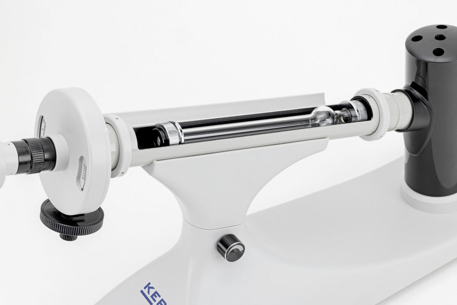 Manual polarimeter optical tube with lens and light.