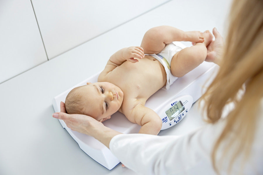 Baby Scale with baby on it, side view