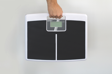 Personal Floor Scale in a hand